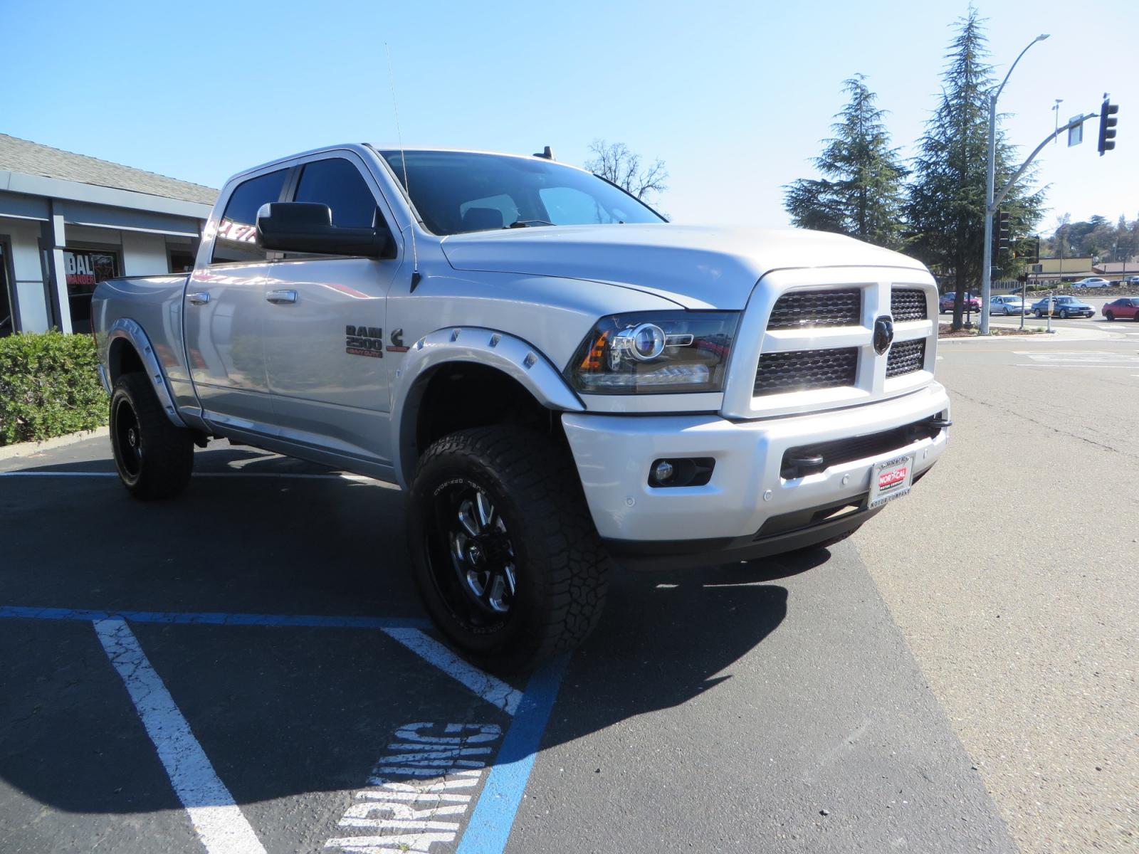 2016 SILVER /BLACK RAM 2500 Laramie Crew Cab SWB 4WD (3C6UR5FL3GG) with an 6.7L L6 OHV 24V TURBO DIESEL engine, 6A transmission, located at 2630 Grass Valley Highway, Auburn, CA, 95603, (530) 508-5100, 38.937893, -121.095482 - Leveled Ram sitting on Fuel Offroad wheels, Falken Wildpeak AT tires, Amp Power steps, Rolling Bed cover, Color matched fender flares, and window tint. - Photo #2